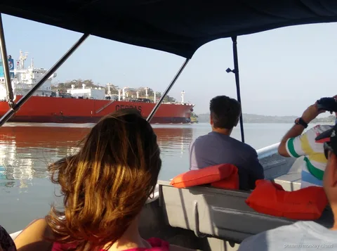 View from a covered boat of a red tanker on the Panama Canal, panama monkey island canal cruise